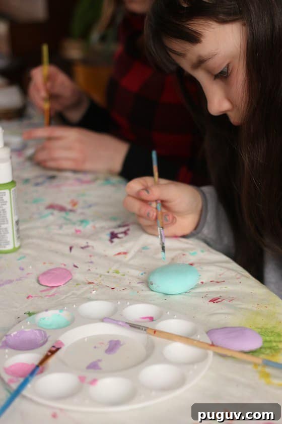 Kids painting stones in Easter colours