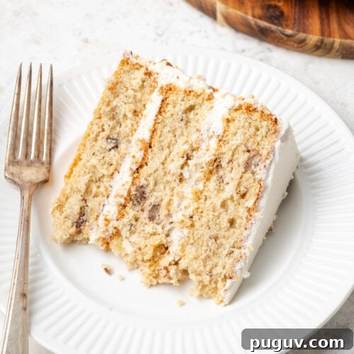 A slice of Italian cream cake served on a white plate.