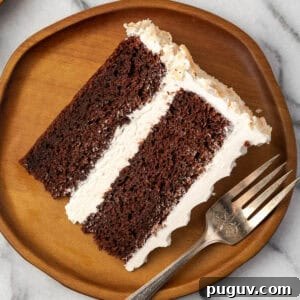 Decadent Chocolate Coconut Cake Recipe (Moist & Easy to Make) 18 A slice of chocolate coconut cake served on a wooden plate.
