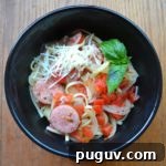 One Pot Italian Pasta in black bowl with basil garnish from www.ApronFreeCooking.com