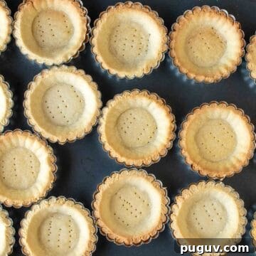 Overhead view of baked tartlet bases.