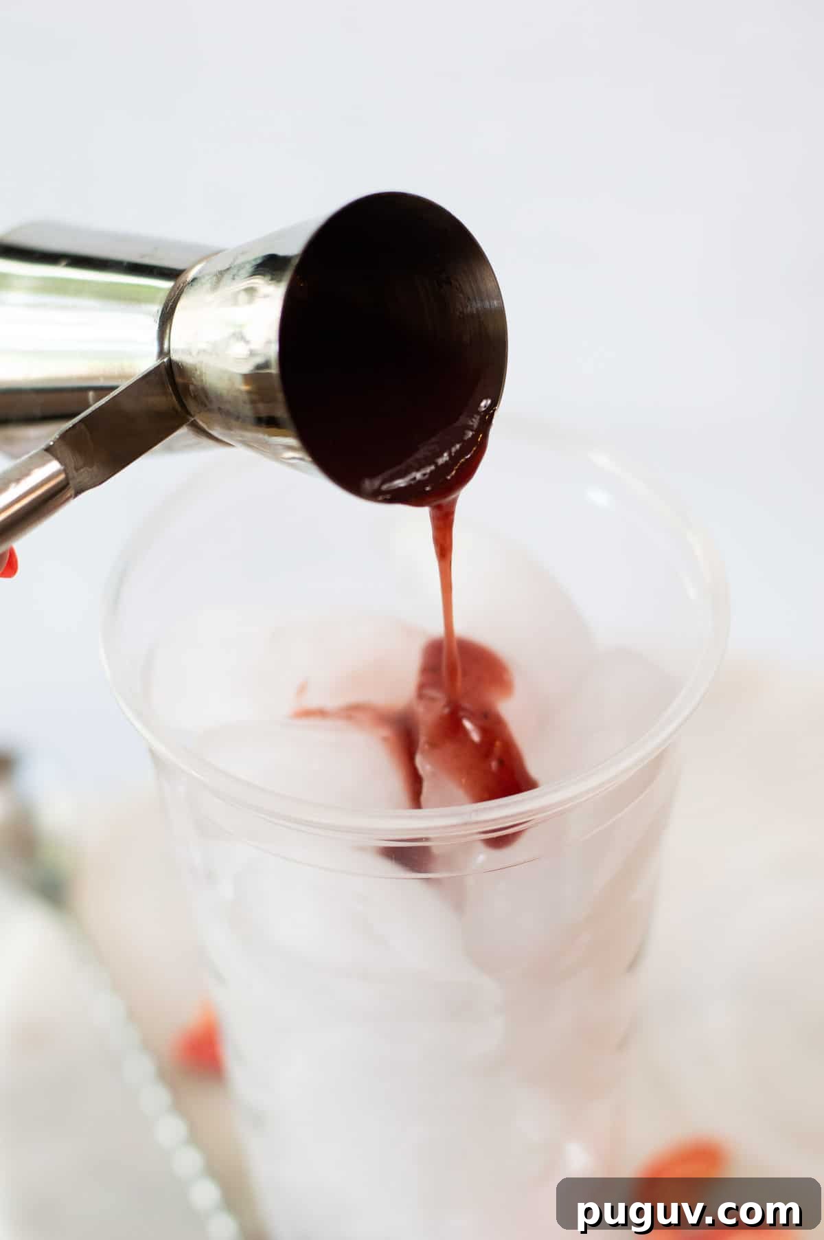 Starbucks Pink Drink Copycat Recipe: How to Make It at Home 4 Starbucks Pink Drink Copycat pouring strawberry syrup