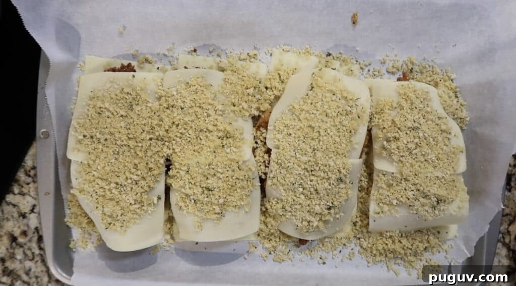 Breadcrumbs on top of sliced cheese