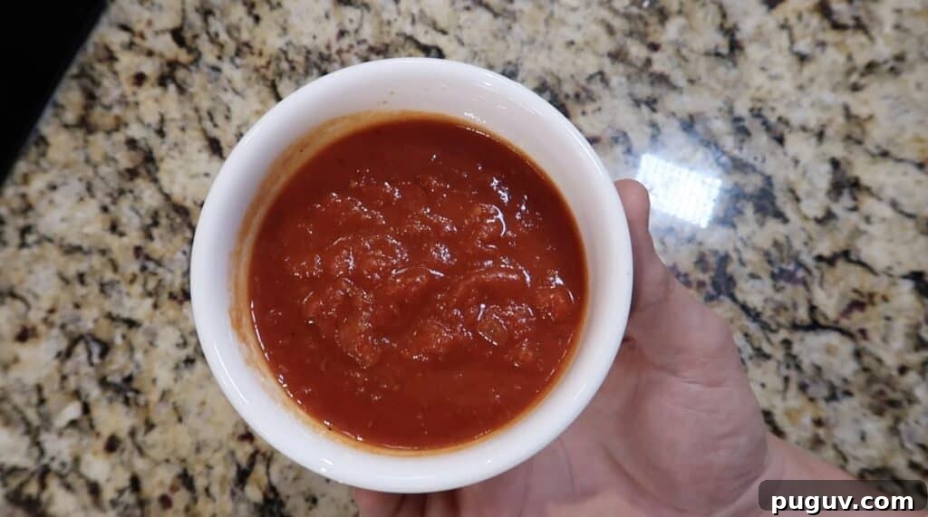 A bowl of heated marinara sauce