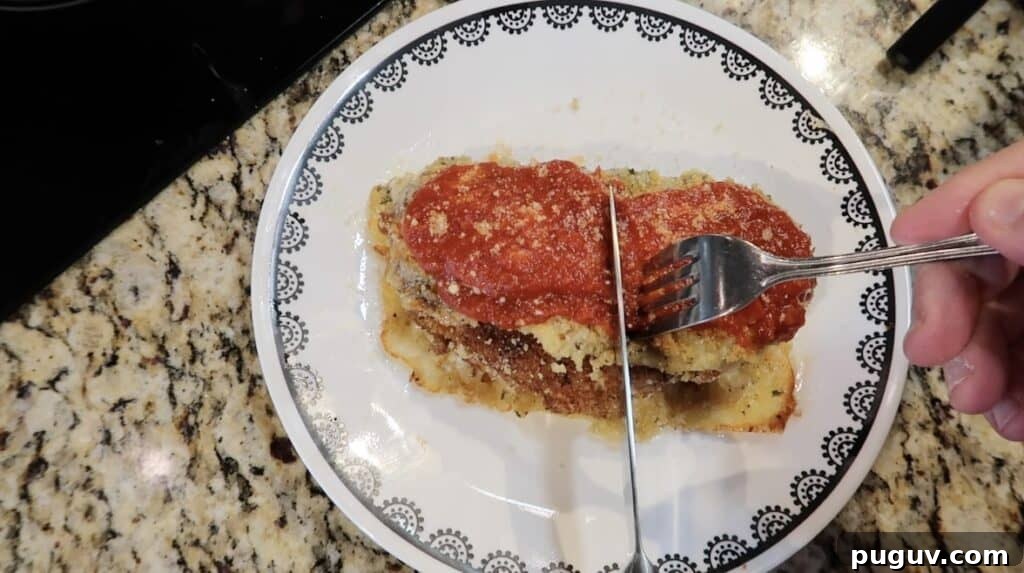 Knife slicing through the center of the cutlet