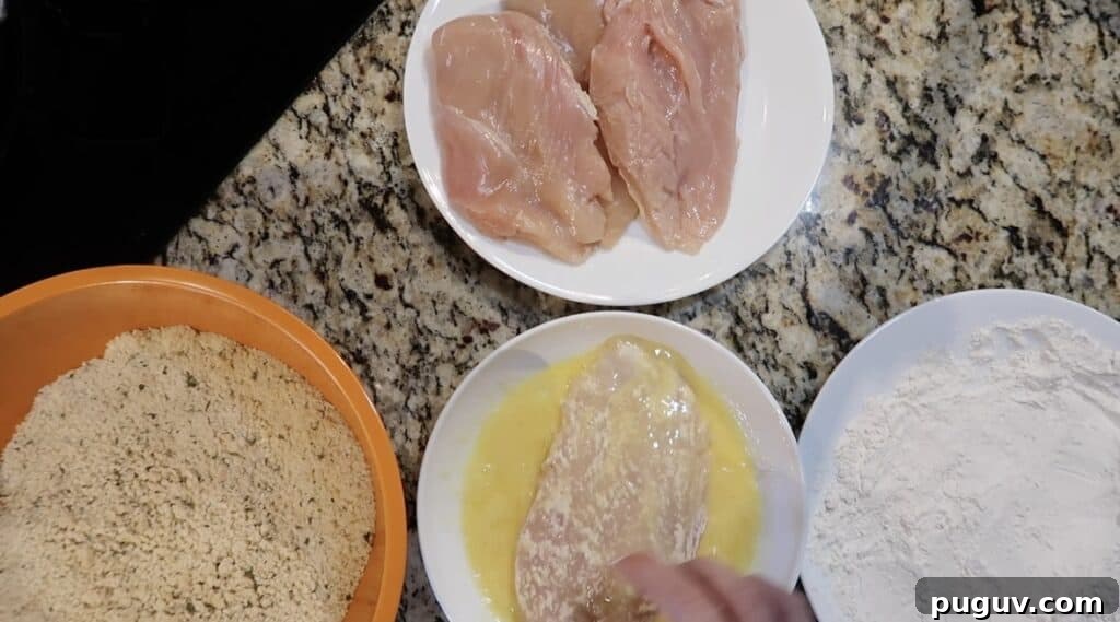 Cutlet with flour is being coated in the egg