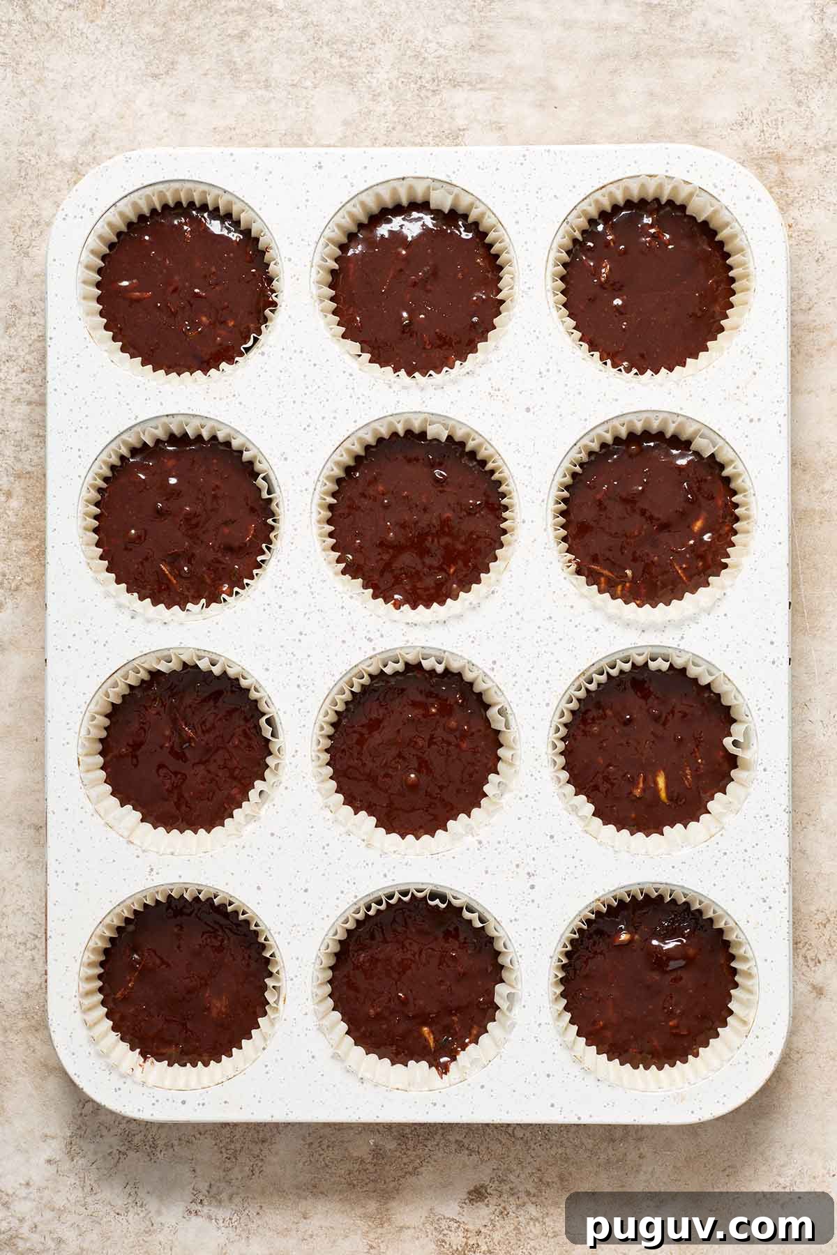 Moist Chocolate Zucchini Cupcakes with Fudgy Cocoa Glaze 5 Cupcake batter divided into a muffin pan.
