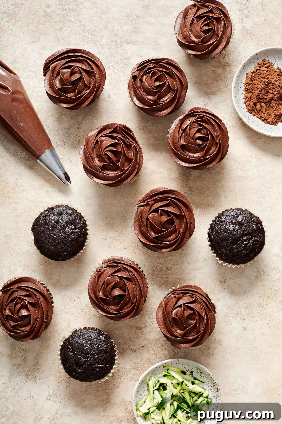 Moist Chocolate Zucchini Cupcakes with Fudgy Cocoa Glaze 7 Overhead view of cupcakes being topped with frosting.