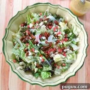 Summer fennel salad with shaved fennel, feta cheese, candied pecans, and watermelon in a large bowl.