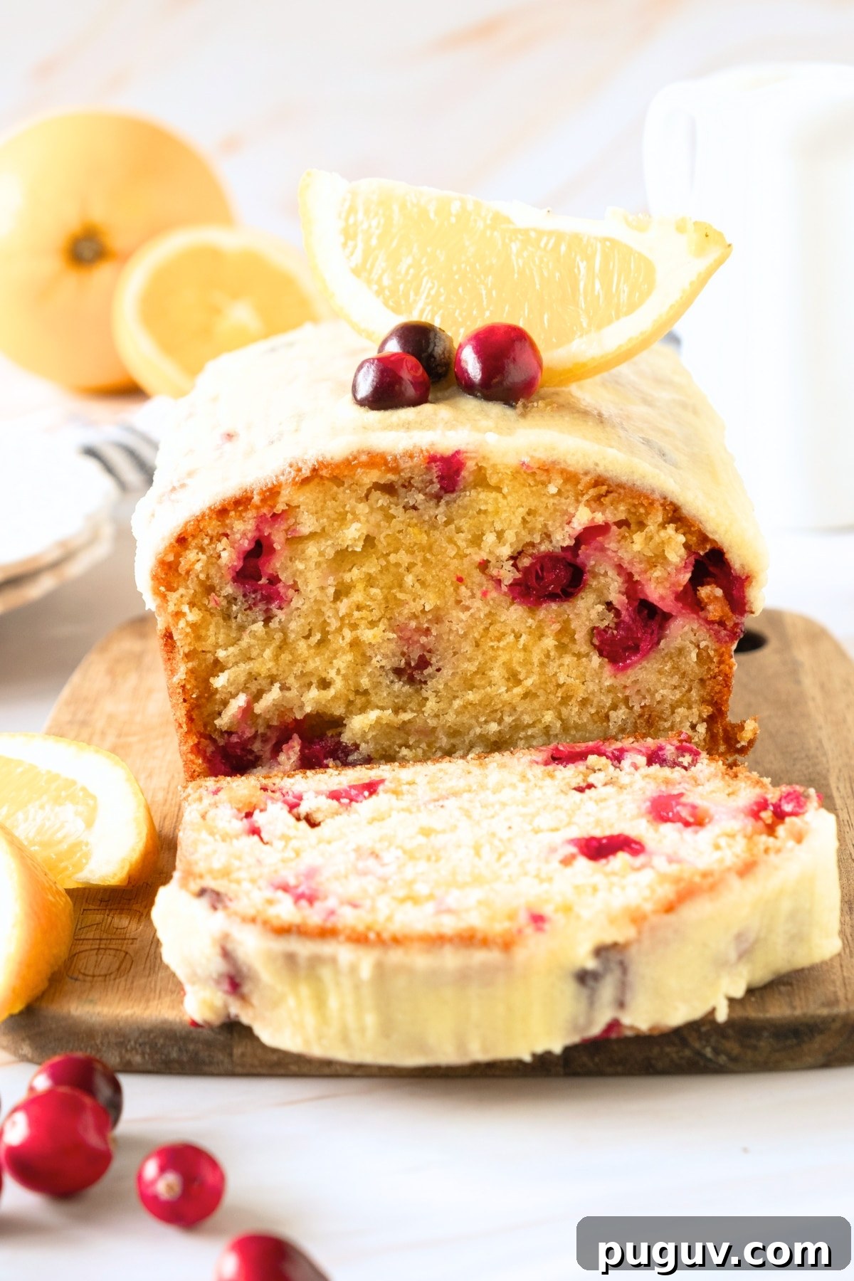 Gluten-Free Cranberry Bread (Dairy-Free) A half-sliced loaf of gluten-free cranberry bread on wooden board.