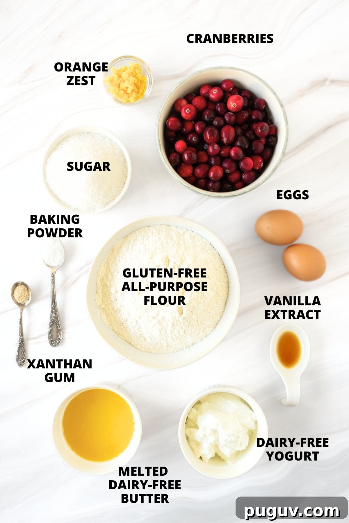 Gluten-Free Cranberry Orange Bread Recipe (Dairy-Free) Ingredients for gluten-free cranberry orange bread recipe laid out on marble board.