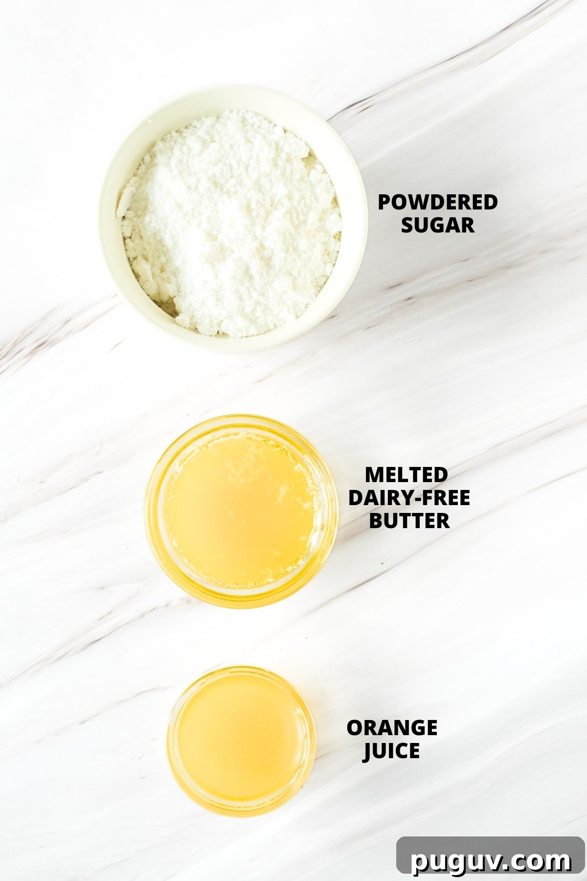 Glazed Cranberry Orange Bread (Gluten-Free,Dairy-Free) Ingredients for orange glaze laid out on marble board.