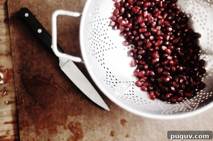 Pomegranate seeds in colander