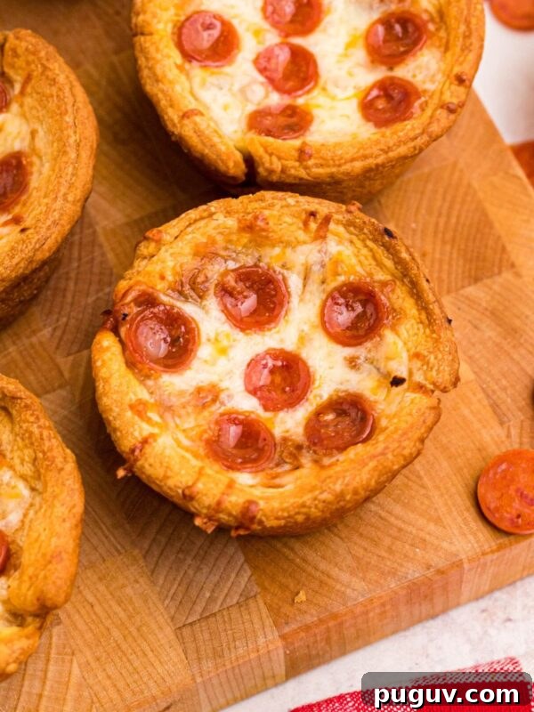 Creamy Beet Hummus Recipe: Vibrant Homemade Dip 9 Golden crusted pizza cupcakes on a wooden cutting board with pepperoni scattered around the table.