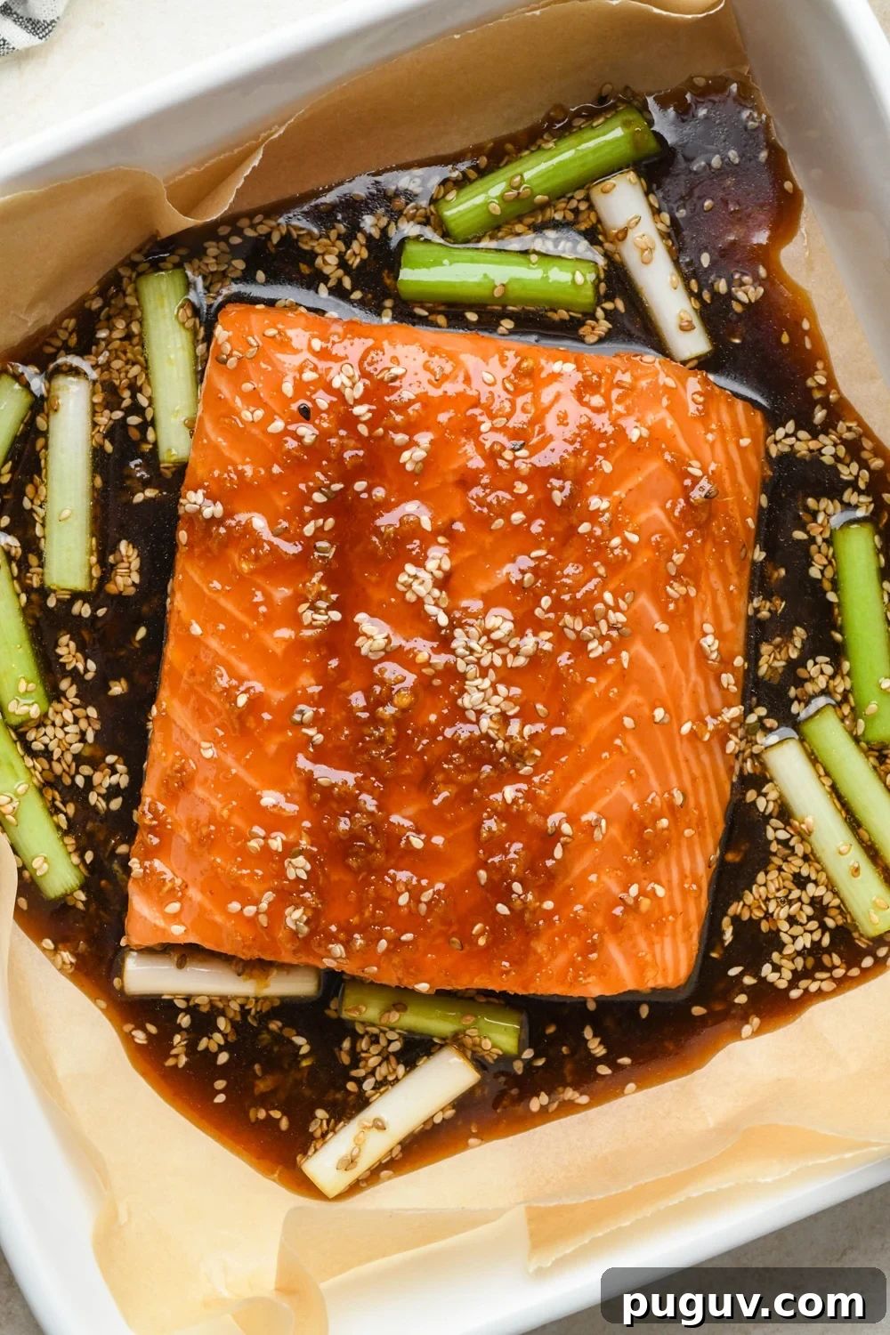 30-Minute Garlic-Ginger Glazed Salmon Recipe (Gluten-Free) 11 How to make garlic ginger salmon: Sauce poured over the salmon filet in baking dish.