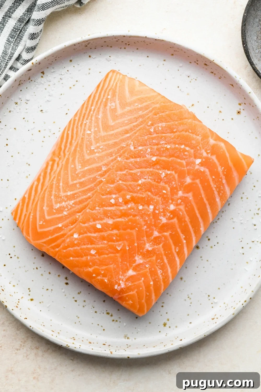 30-Minute Garlic-Ginger Glazed Salmon Recipe (Gluten-Free) 7 How to make garlic ginger salmon: Salmon filet patted dry on a small ceramic plate, topped with a sprinkle of kosher salt.