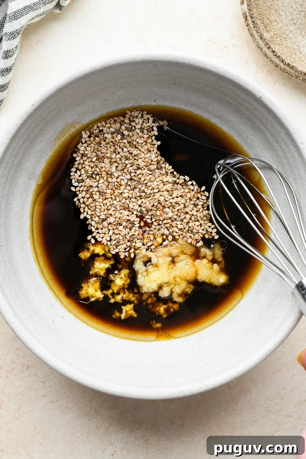 30-Minute Garlic-Ginger Glazed Salmon Recipe (Gluten-Free) 9 How to make garlic ginger salmon: Sauce ingredients in a small grey ceramic bowl, before mixing together.