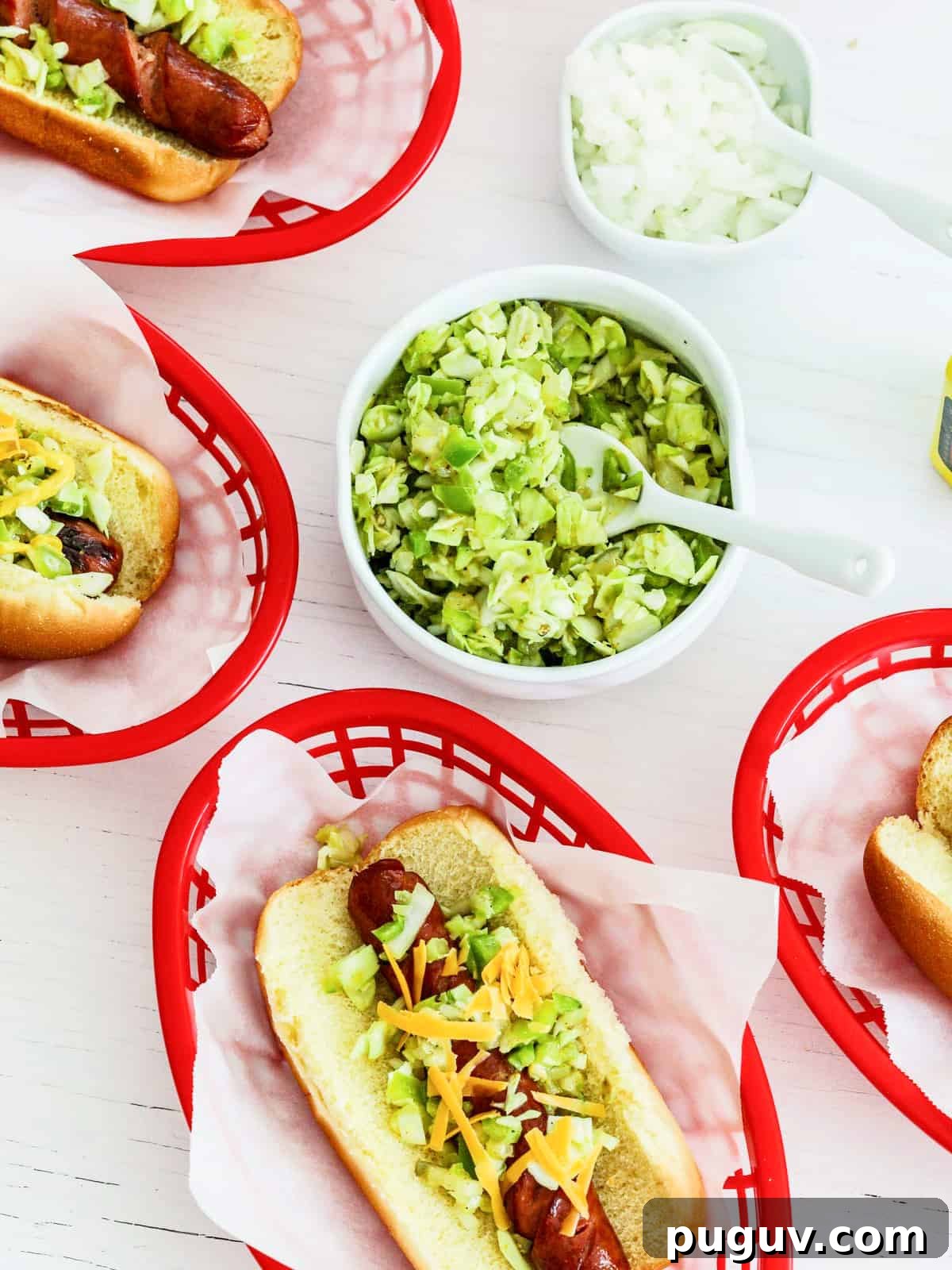 Red food baskets filled with hot dogs and toppings at a cookout party.