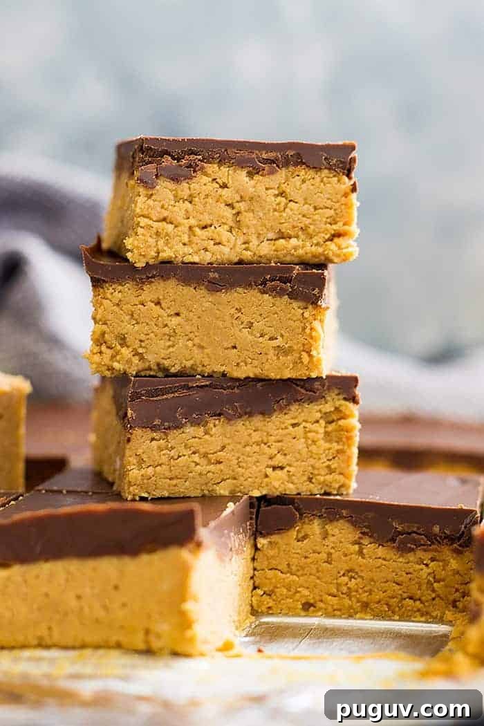 No-Bake Chocolate Peanut Butter Bars Recipe: No Oven Needed 3 No bake chocolate peanut butter bars stacked on top of each other in a tall tower.