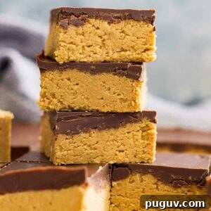 No bake chocolate peanut butter bars stacked on top of each other in a tall tower.