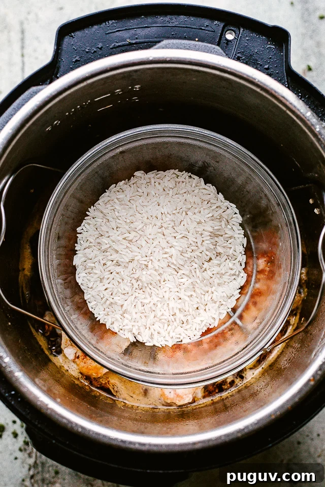 Sweet and savory honey garlic chicken is a quick and flavorful dinner that will make your entire family happy. Ready in under 30 minutes! Placing a dish of rice in an Instant Pot to cook.