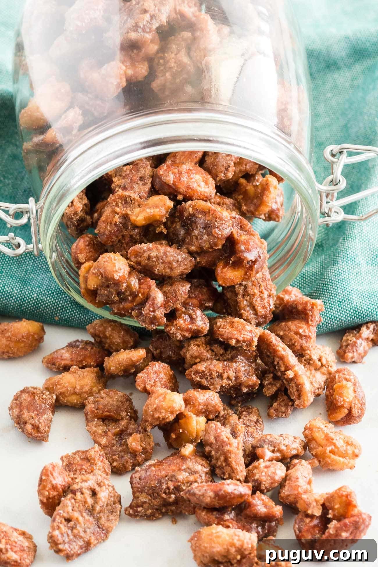 candied nuts being portioned into mason jars for hostess gifts