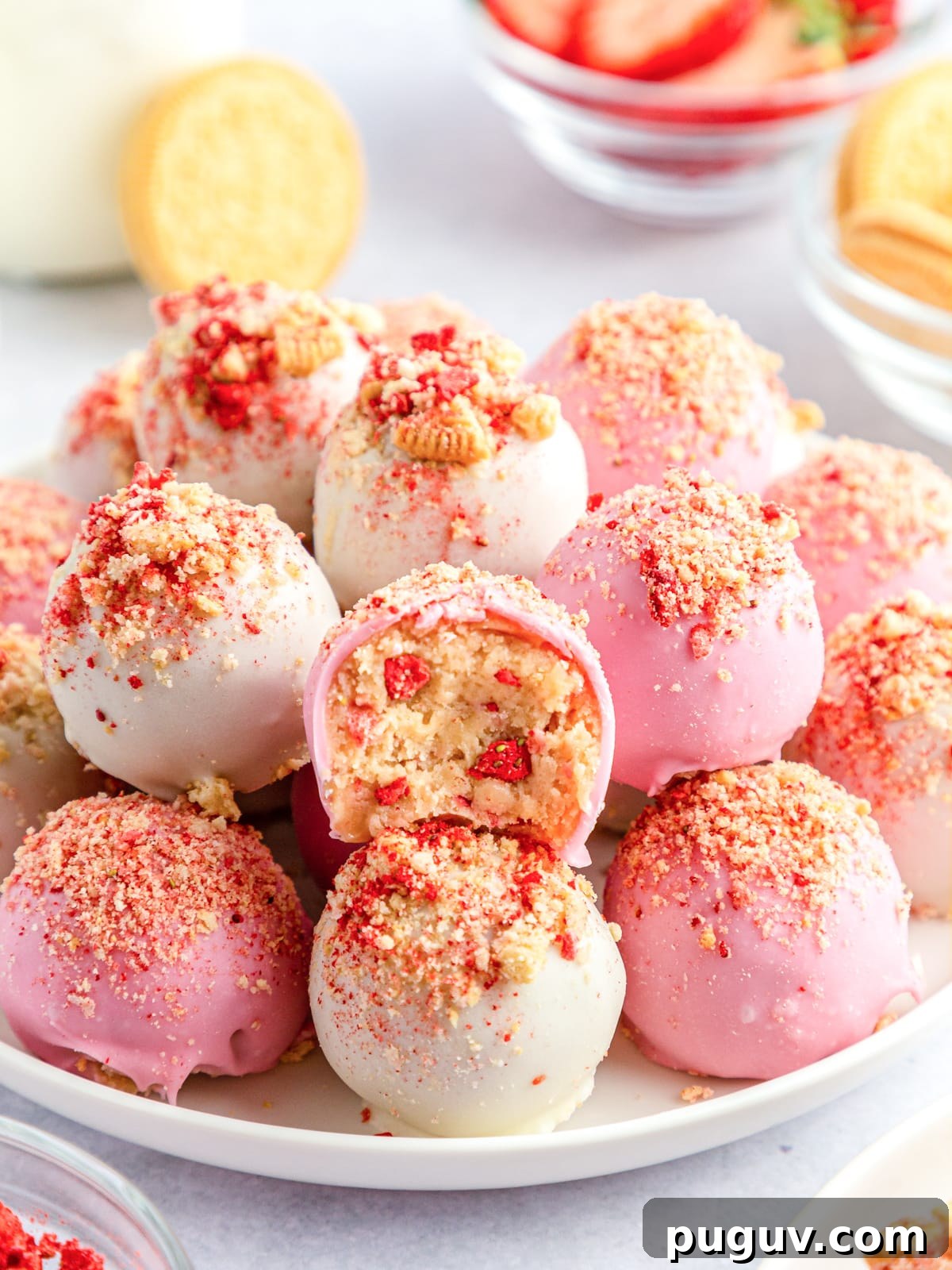 Strawberry Crunch Cookie Balls Recipe — No-Bake Dessert Bites 11 strawberry crunch cookie balls stacked on a white plate