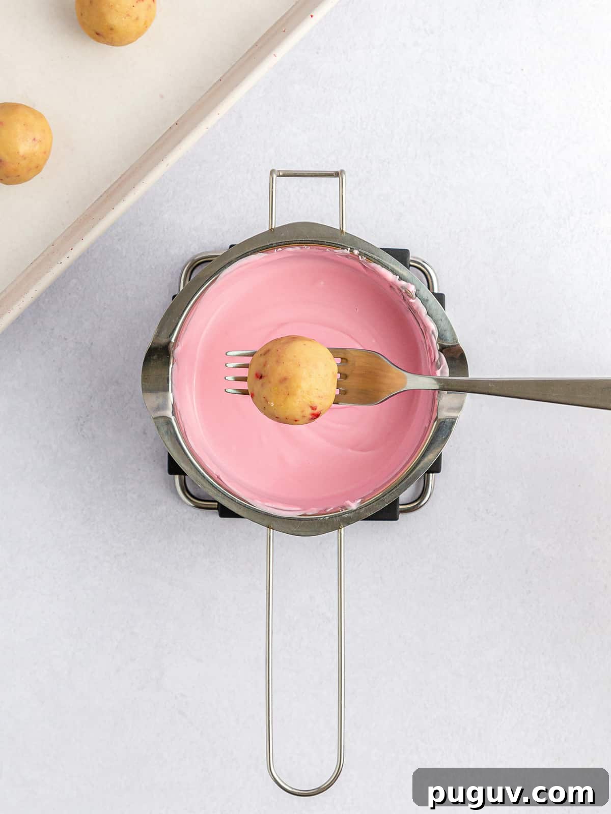 Strawberry Crunch Cookie Balls Recipe — No-Bake Dessert Bites 8 cookie ball on a fork over melted pink chocolate