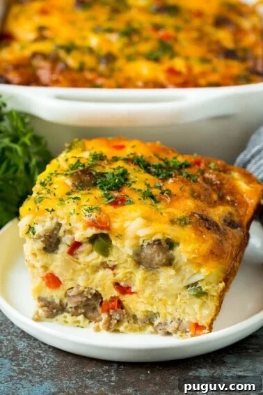 A piece of sausage casserole filled with hash browns, eggs and cheese.