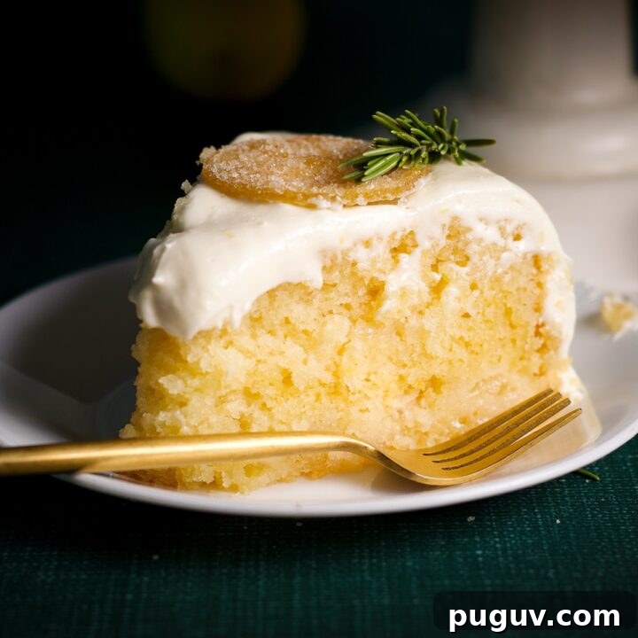 A slice of elderflower lemon cake on plate with a fork.