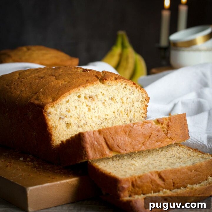 A loaf of banana bread that's been partially sliced.