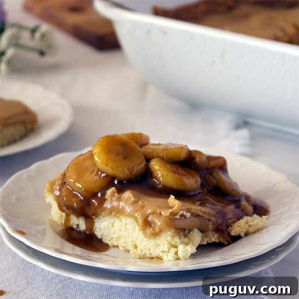 Decadent Bananas Foster Butter Cake Recipe for Dessert Fans 5 A piece of Bananas Foster Cake on a white plate, ready to eat.
