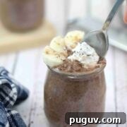 30 Nourishing Dairy- and Gluten-Free Snacks for Breastfeeding 4 Chocolate banana chia pudding in a mason jar with a spoon.