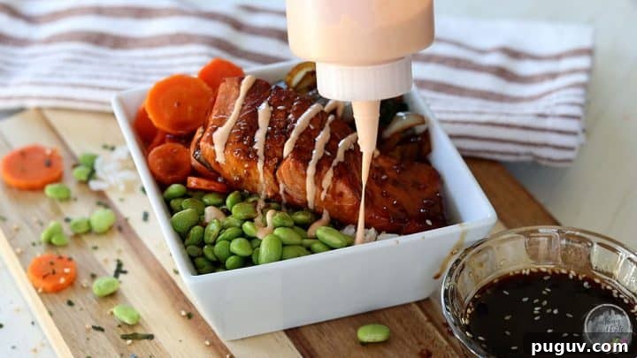 Creamy Yum Yum Sauce Recipe: Simple Homemade Japanese Steakhouse Sauce 6 Drizzling the japanese steakhouse sauce over a piece of salmon in a white bowl.