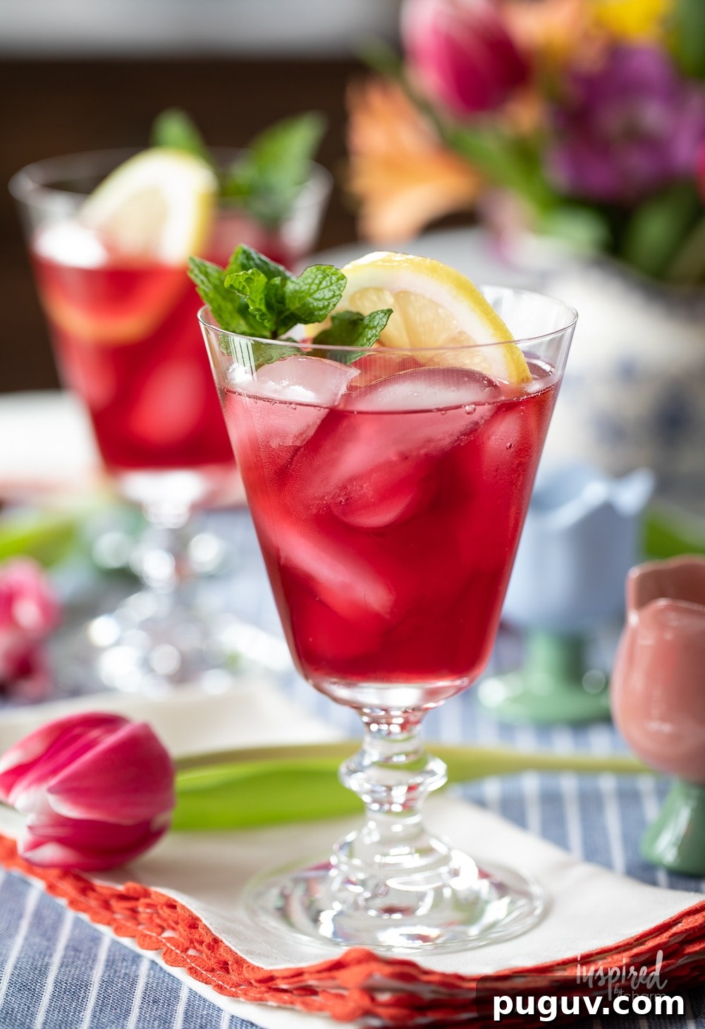 Pink Tulip Cocktail Recipe: Floral Vodka Drink Guide 11 pink tulip cocktail with mint and lemon garnish on a napkin with tulips.