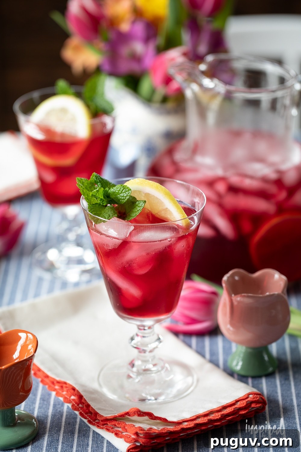 Pink Tulip Cocktail Recipe: Floral Vodka Drink Guide 3 tulip cocktail served in a glass with more in a pitcher.