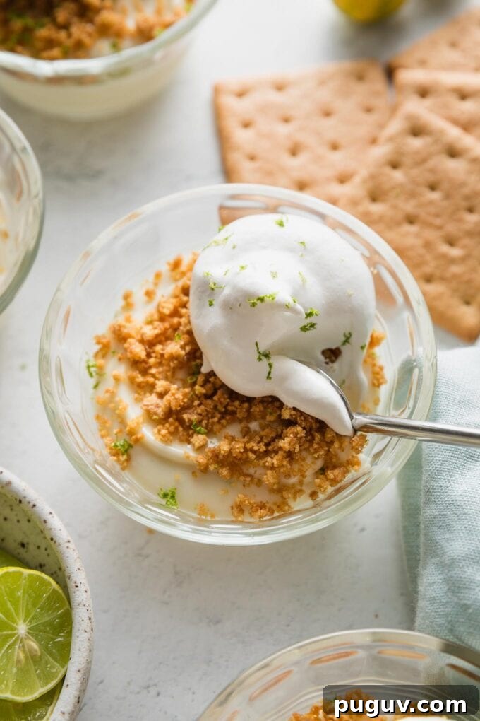 Small custard dish with an individual portion of no bake key lime pie served "upside down," with graham cracker crumbs on top.