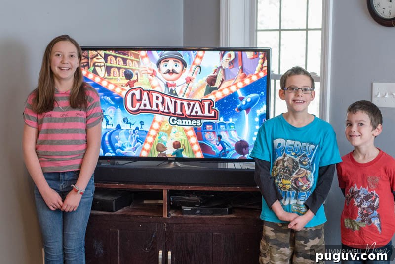 How a Gaming Console Can Bring Your Family Together 14 a boy and a girl standing in front of a tv with a Nintendo Switch Carnival game on it