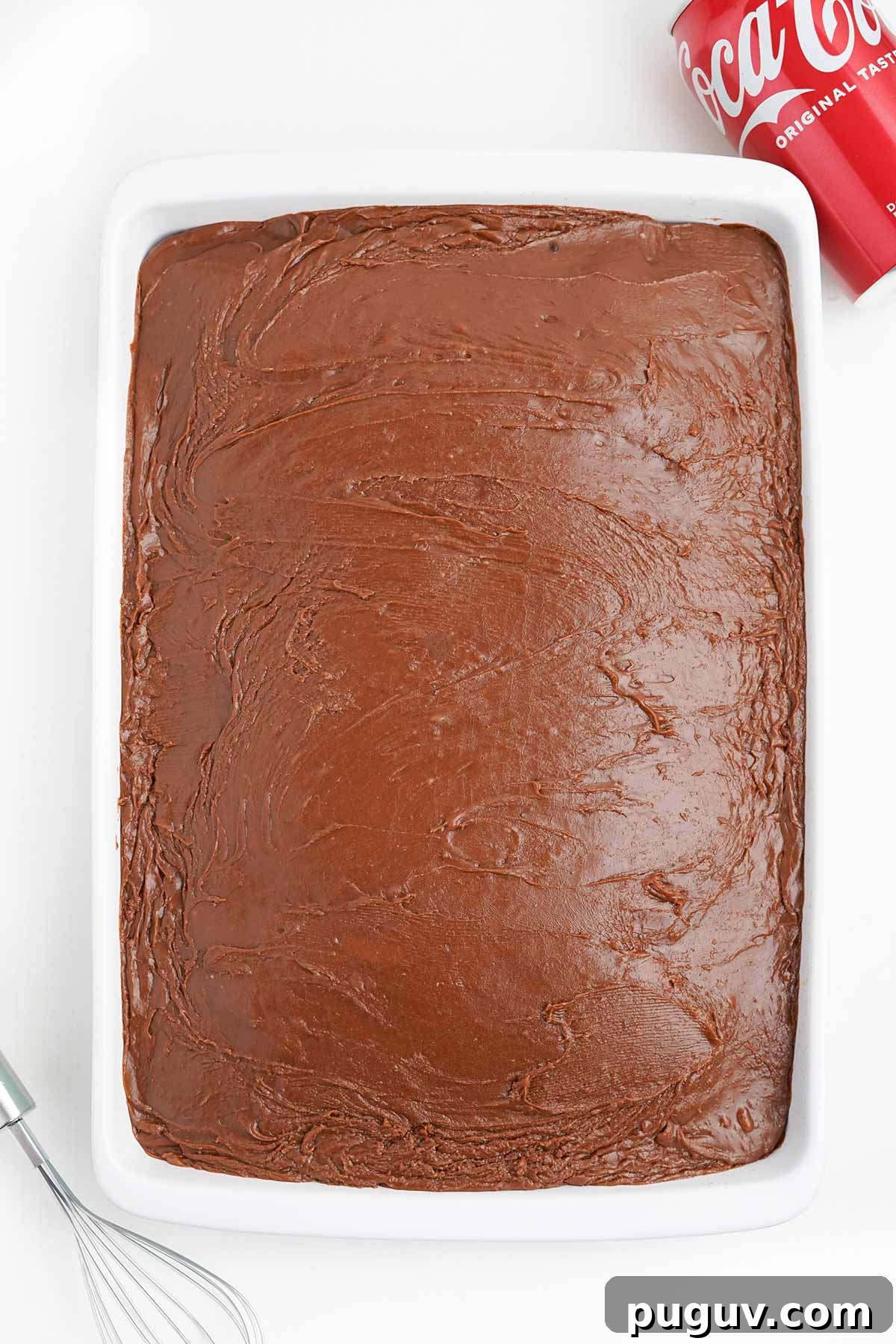 Copycat Cracker Barrel Coca-Cola Cake Recipe You’ll Love 10 Finished coca cola cake in the pan with icing on top.