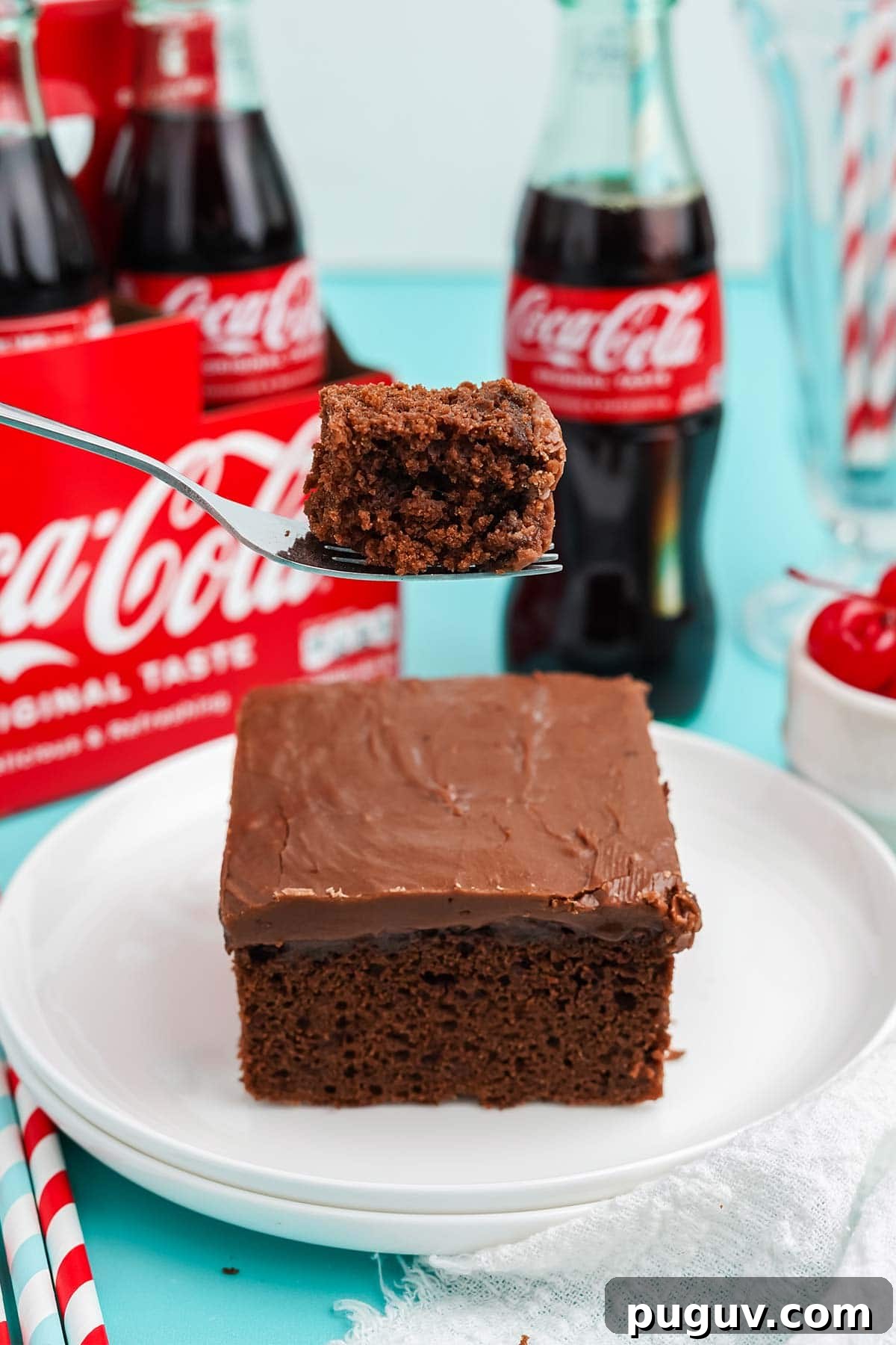 Copycat Cracker Barrel Coca-Cola Cake Recipe You’ll Love 11 Coca cola cake served up on a plate with a bite on a fork above the cake.