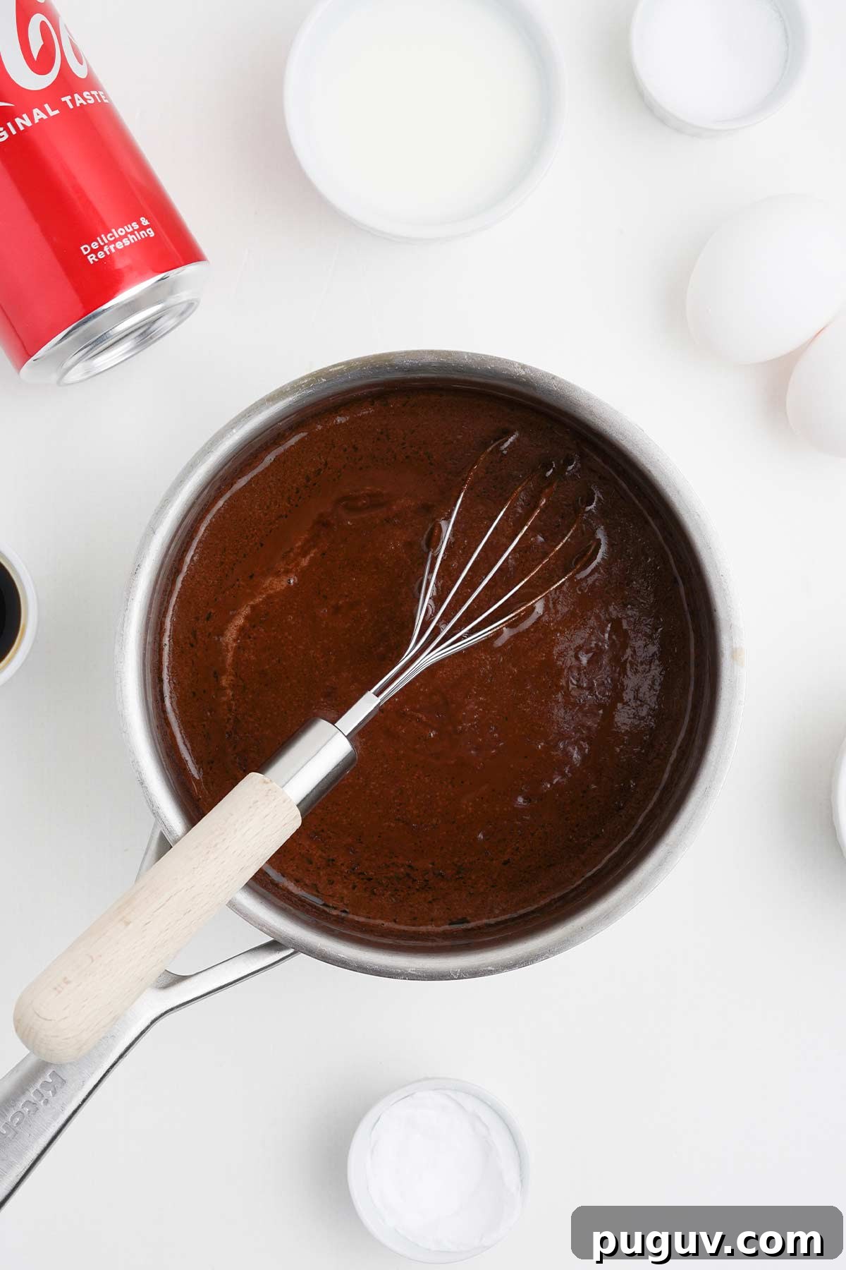 Copycat Cracker Barrel Coca-Cola Cake Recipe You’ll Love 6 The cola reduction for coca cola cake in a saucepan.