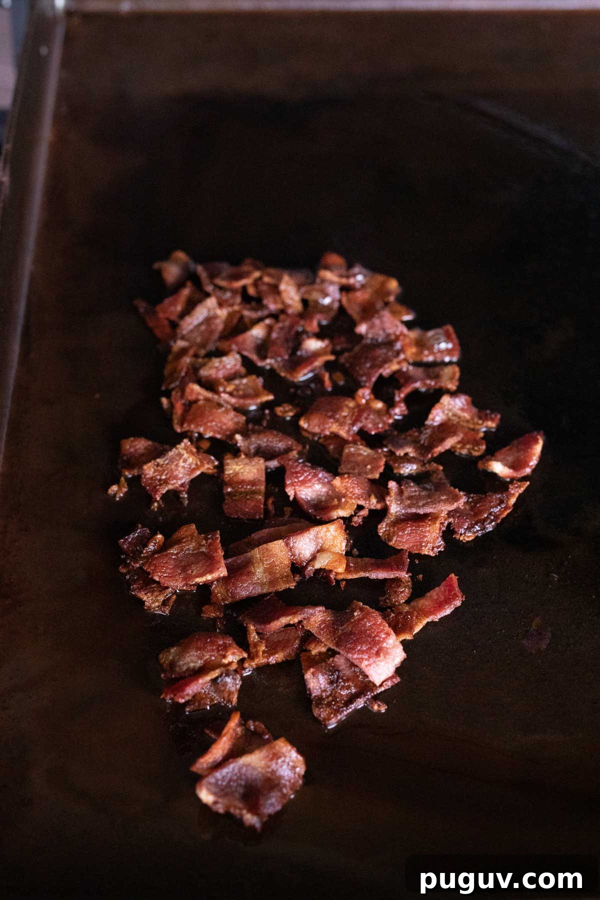 Diced cooked bacon on the griddle