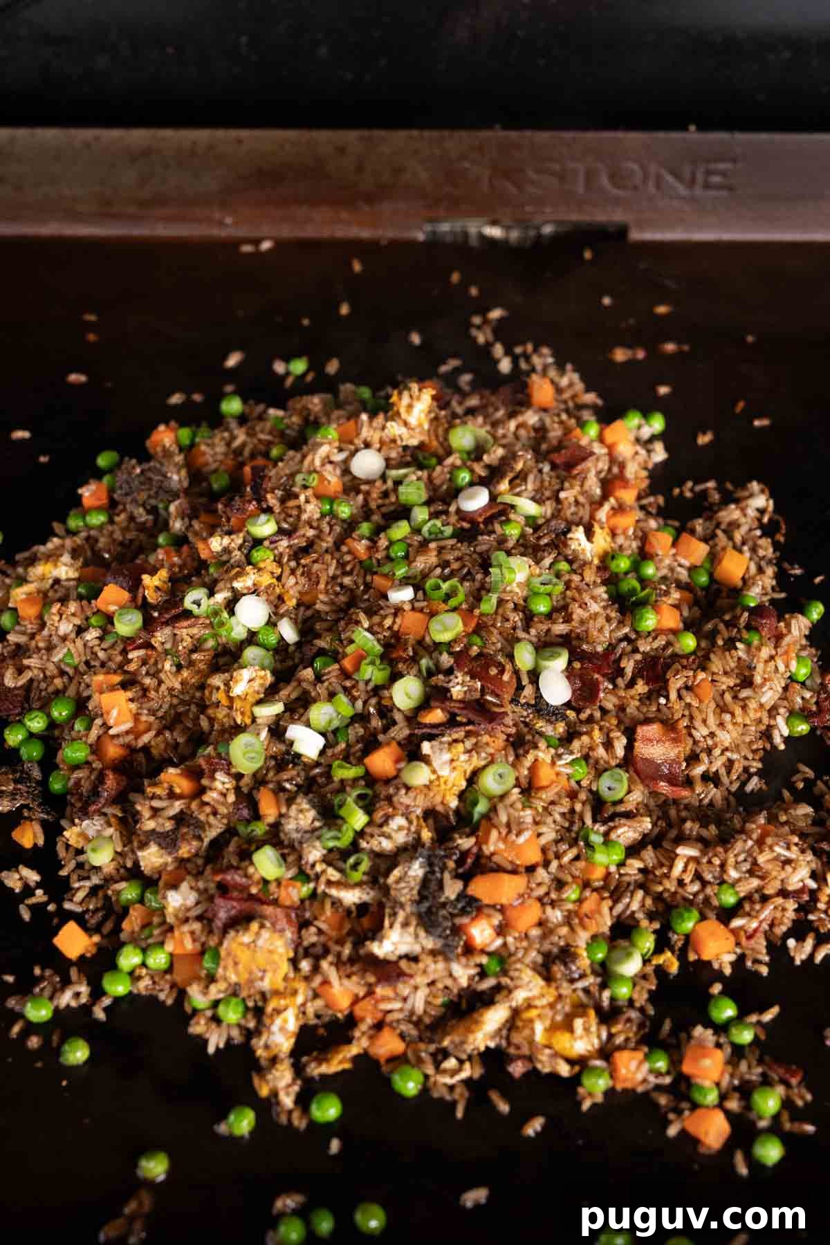  Breakfast Fried Rice on the griddle topped with green onions