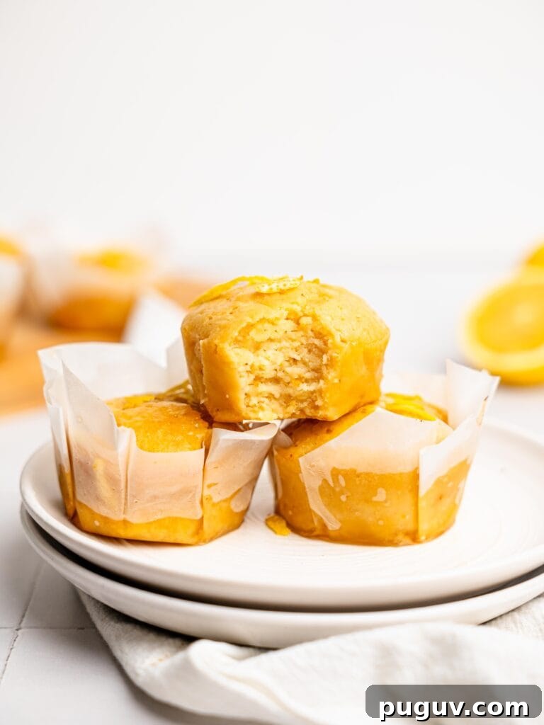 Lemon Drizzle Muffins That Actually Taste Indulgent 8 Lemon Drizzle Muffins on a plate.