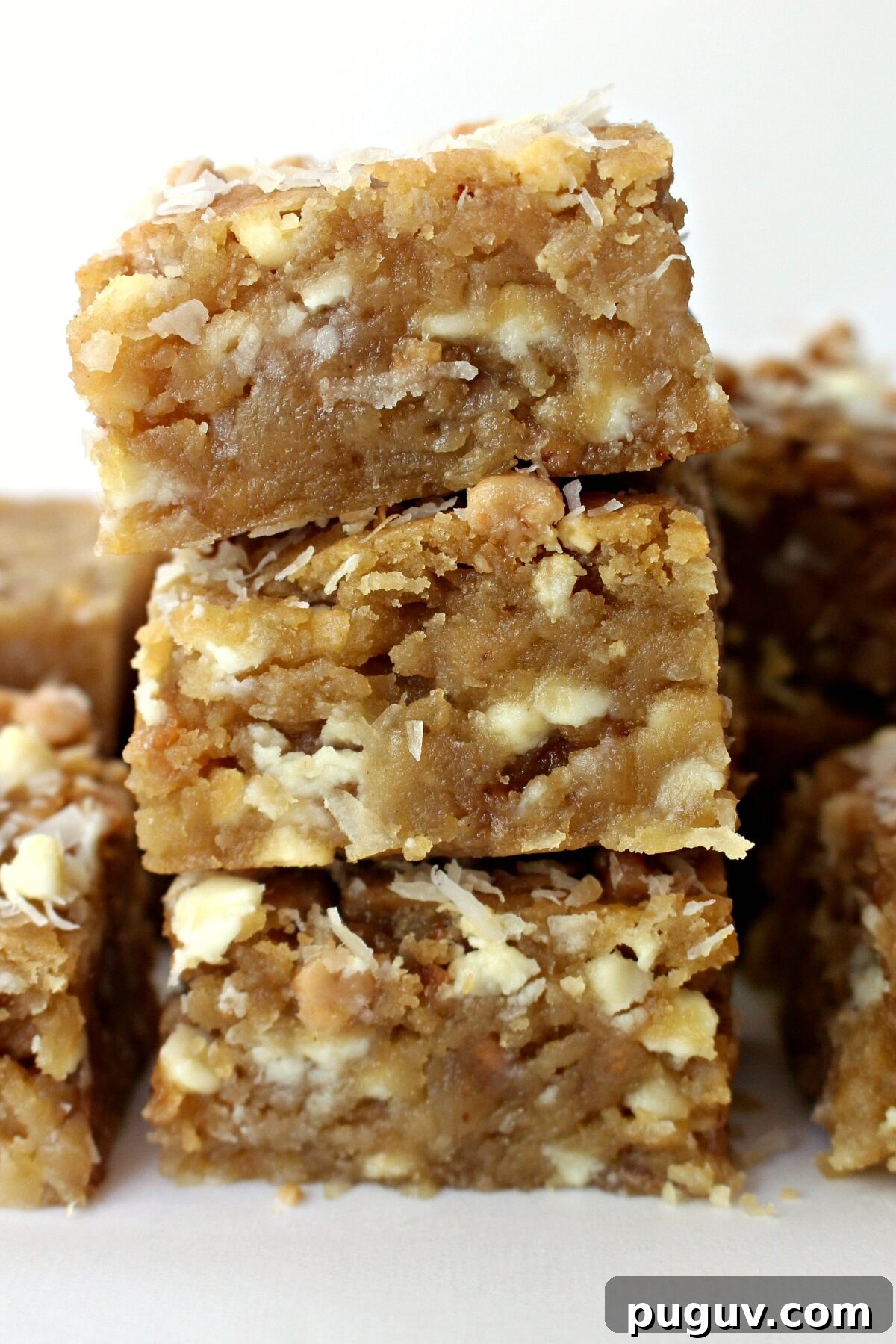 Coconut Milk Blondies Recipe: Chewy, Dairy-Free Dessert 5 Stack of three Coconut Blondies showing thick, soft interior.