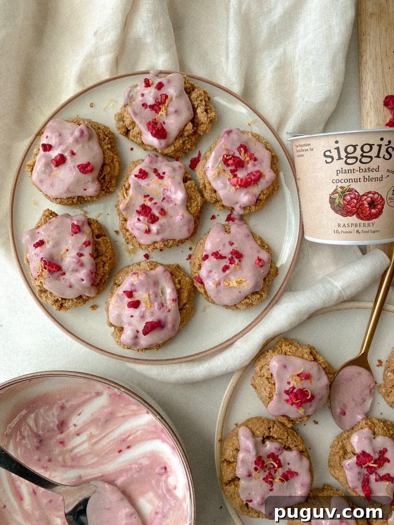 cookies with raspberry yogurt frosting on plates with cup of yogurt