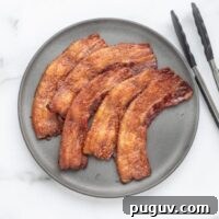 A plate with crisp baked bacon.