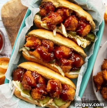 overhead shot of 3 sandwiches in blue dish surrounded by ingredients