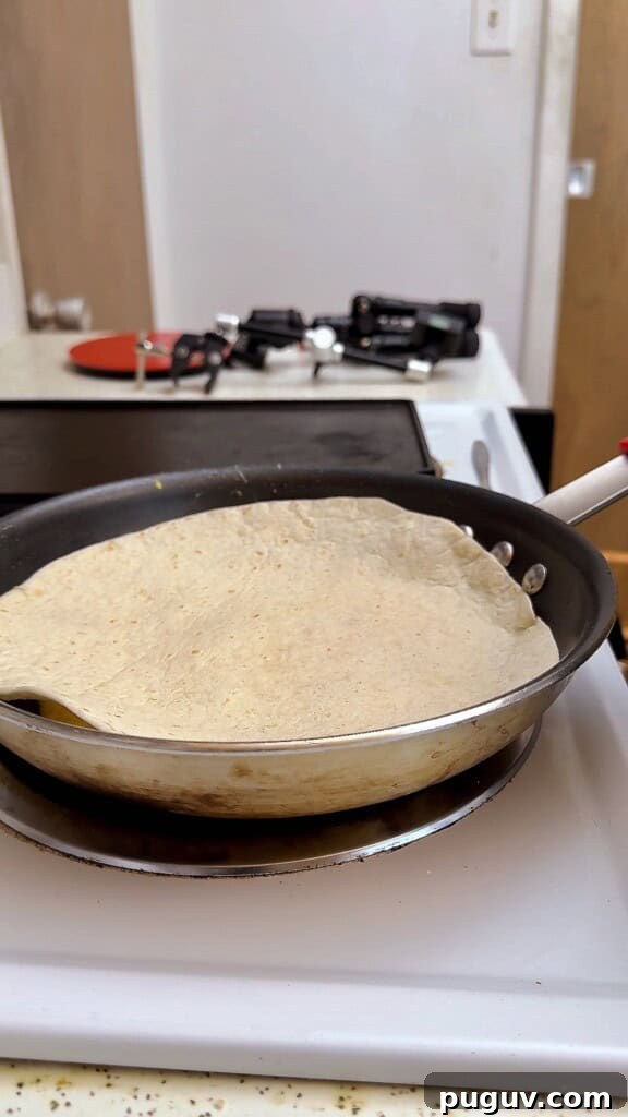 15-Minute Egg & Cheese Breakfast Quesadilla Recipe 7 top the eggs with the tortilla