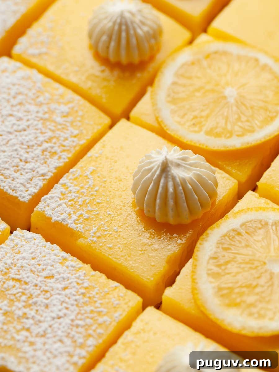 Gluten-Free Lemon Bars Recipe with Tangy Shortbread Crust 10 lemon bars with a shortbread crust topped with powdered sugar on parchment paper